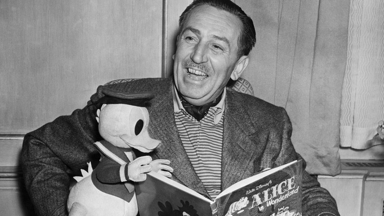 Walt Disney with a doll of Daffy Duck