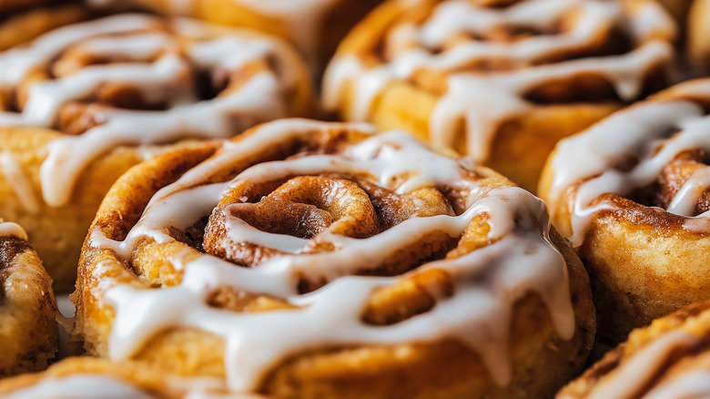 Close-up of cinnamon rolls with drizzle of icing