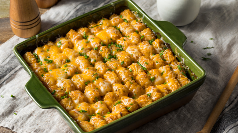 Tater tot hotdish in green casserole dish