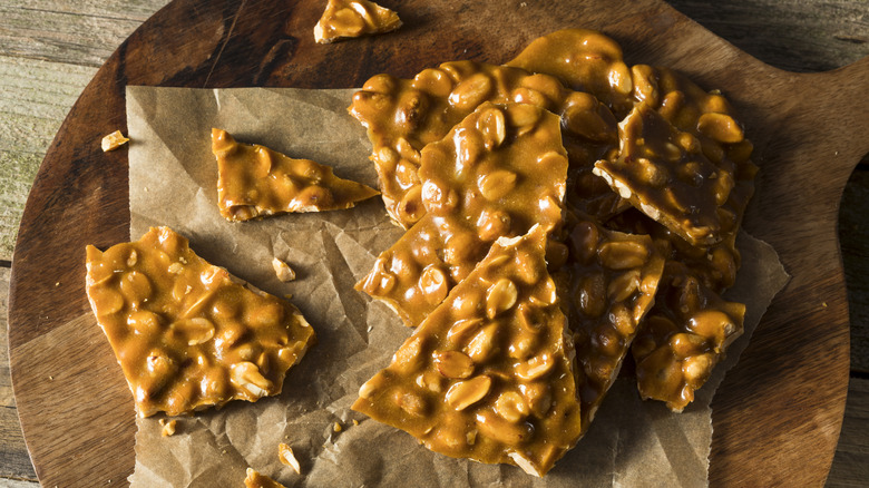 Peanut brittle on wood board