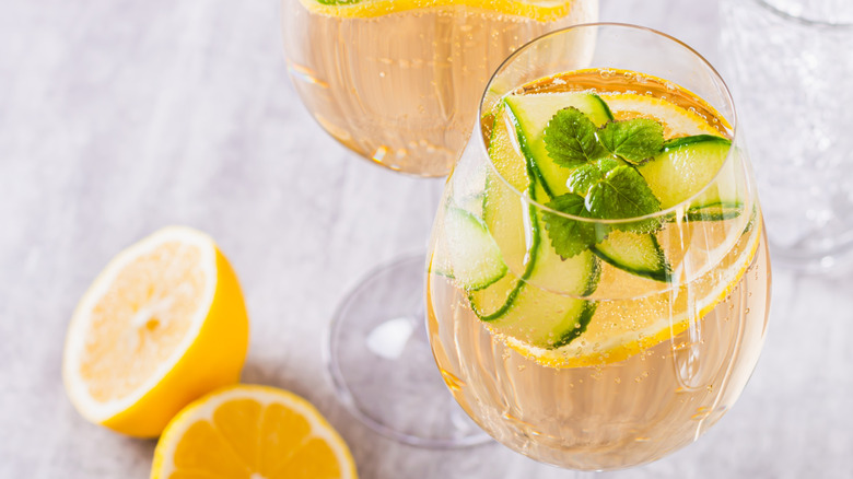 close up of spritz cocktail with cucumbers