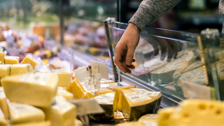Man selecting cheeses