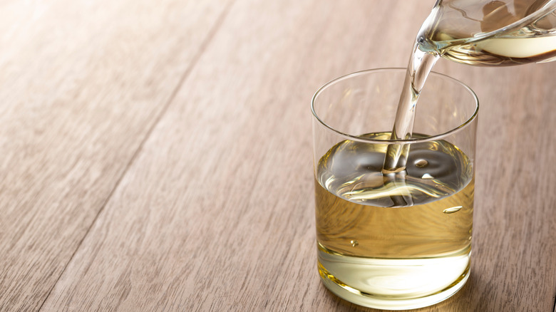 pouring Japanese cooking wine in a cup