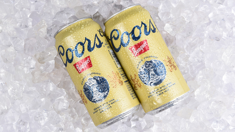 Two cans of Coors Banquet on ice