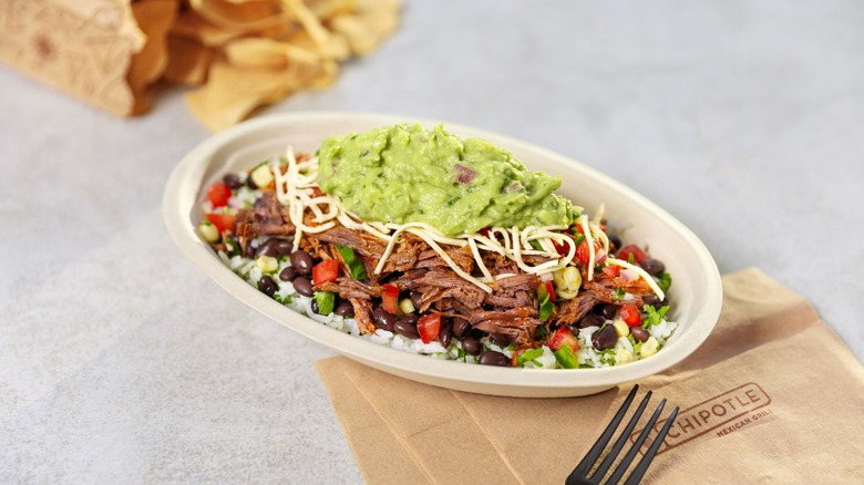 Chipotle carnitas bowl with cheese and guacamole