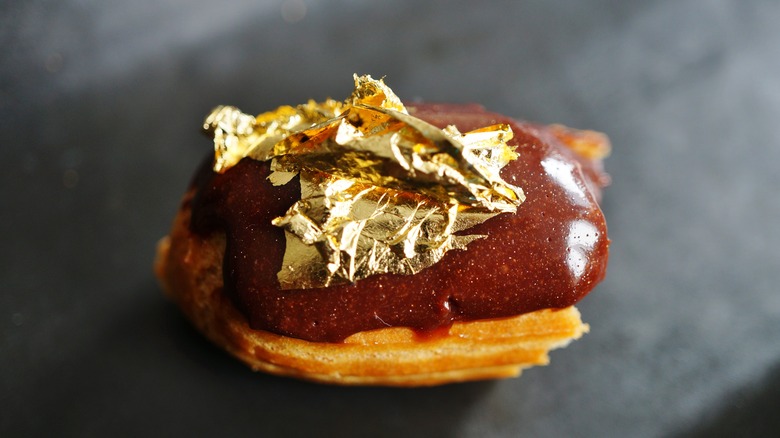 eclair topped with gold leaf